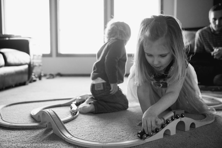Sister plays with trains - Lake Oswego in-home family photography